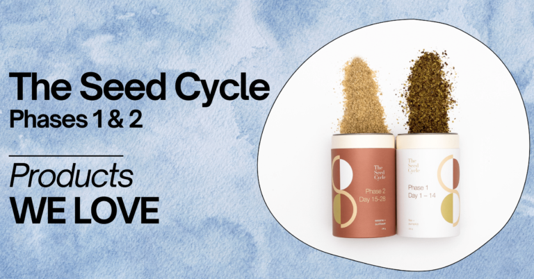 A promotional image featuring 'The Seed Cycle Phases 1 & 2' products on a light blue watercolor background. The image shows two cylindrical containers, one for Phase 1 (Days 1-14) with flax and pumpkin seeds, and one for Phase 2 (Days 15-28) with sesame and sunflower seeds, both with seeds pouring out. The containers are displayed within a white oval. The text on the left side of the image reads 'The Seed Cycle Phases 1 & 2' in large black letters, followed by 'Products WE LOVE' in smaller black letters.