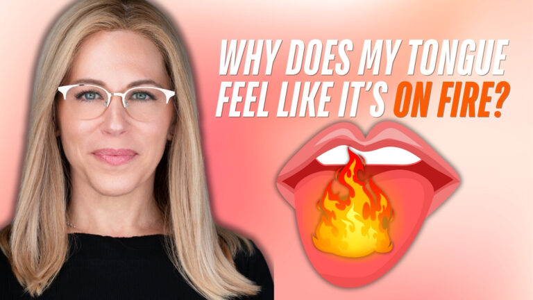 A person with long blonde hair and white glasses, wearing a black top, is shown on the left side of the image. On the right side, there is a graphic of a pink tongue with yellow and orange flames emerging from it. The background is a gradient of pink and peach. Bold white and orange text at the top reads, "WHY DOES MY TONGUE FEEL LIKE IT'S ON FIRE?"